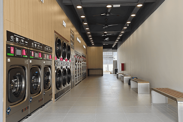 OASIS commercial laundry equipment in a neighborhood laundromat
